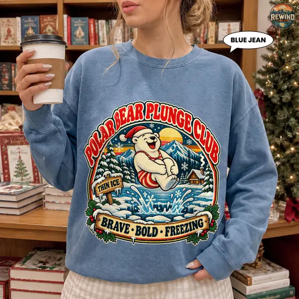 Blue Spruce crewneck sweatshirt laid flat on a white background with a retro polar bear ice swimming graphic, Polar Bear Plunge Club lettering and a Brave Bold Freezing slogan.